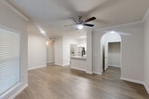 This 640 square foot apartment in Richmond, TX, combines efficiency with modern comfort. The single-floor layout maximizes space utilization, featuring one bedroom and one bathroom. The kitchen stands out with its sleek design, boasting white cabinetry, granite countertops, and stainless steel appliances including a built-in microwave and electric range. The bedroom, measuring 130 square feet, offers ample space and is brightened by large windows with horizontal blinds. The bathroom, while compact, is functional and well-appointed. The apartment includes an in-unit laundry area with a top-loading washer, adding convenience to daily living. Throughout the space, neutral tones dominate, with off-white walls and a mix of carpeted and wood-look flooring. The property also features two closets for storage and two hallways for easy navigation. Ceiling fans in the living areas provide additional comfort. This apartment offers a balance of practicality and contemporary style, ideal for those seeking a modern living space in a suburban setting.
