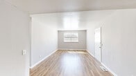 This 1-bedroom, 1-bathroom unit offers a clean, modern aesthetic across its single-floor layout. Warm-toned luxury vinyl plank flooring runs consistently throughout every room, lending continuity and a fresh, updated feel to the entire space.

The living room is bright and open, with neutral gray walls, crisp white trim, and a window fitted with blinds that allow natural light to fill the room. The space flows into additional areas with ease, reflecting an efficient and functional floor plan.

The bedroom is a comfortable, well-proportioned retreat equipped with a ceiling fan, a built-in closet with shelving, and a window that brings in generous natural light. The neutral color palette and clean lines keep the room feeling airy and versatile.

The kitchen is a standout feature, showcasing white shaker-style cabinetry with brushed nickel hardware, striking marble-look quartz countertops, and a light subway tile backsplash. The galley-style layout maximizes counter and storage space efficiently.

The bathroom continues the elevated design language with matching marble-look quartz countertops, a white vanity, a full tub-shower combo, and classic board-and-batten wainscoting along the lower walls, adding a refined architectural detail.

Overall, this unit presents a cohesive, move-in-ready space with thoughtful modern updates throughout.