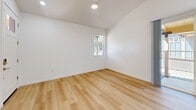 This 820 square foot single-story residence in Flagstaff, Arizona, offers a well-designed living space with two bedrooms and two bathrooms. The home features a modern, open-concept kitchen and living area, maximizing the use of space. The kitchen boasts light-colored cabinetry, stainless steel appliances, and a decorative tile backsplash, creating a stylish and functional cooking environment. An island with a white countertop provides additional workspace and casual dining options.

The primary bedroom, measuring 160 square feet, offers ample space and is equipped with a ceiling fan for comfort. Both bedrooms feature carpeted floors and windows that allow natural light to filter in. The bathrooms are designed with clean lines, featuring white fixtures and light wood-look flooring. One bathroom includes a shower-tub combination with a curved shower rod for added space.

Throughout the home, a mix of carpeted and wood-look flooring creates a cohesive and modern aesthetic. The living areas benefit from natural light through strategically placed windows, some with blinds for privacy control. The property also includes two closets for storage, ensuring a clutter-free living environment. With its efficient layout and contemporary finishes, this Flagstaff home offers comfortable living in a compact footprint.