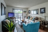 Located at 550 Paularino Ave in Costa Mesa, California, this one-bedroom, one-bathroom residence offers a thoughtfully designed single-floor layout. The living room serves as the heart of the home, featuring hardwood-style flooring, a textured ceiling, and a sliding glass door that opens to a private patio — ideal for enjoying the Southern California climate. Natural light fills the space throughout the day, creating a warm and inviting ambiance.

The galley-style kitchen is efficiently laid out with warm wood cabinetry, granite-style countertops, track lighting, and white appliances, including a range and dishwasher. A breakfast bar connects the kitchen to the adjacent dining area, which comfortably accommodates a full dining set beneath a ceiling fan.

The generously sized bedroom features plush carpeting, a large window with outdoor views of lush greenery, and ample room for full-sized furniture. It provides a calm, restful retreat.

The bathroom is a standout feature, offering an extended granite-topped vanity with warm wood cabinetry, a large mirror, built-in storage tower, and hardwood-style flooring — combining practicality with a refined finish.

Throughout, the residence maintains a clean, neutral palette that enhances its sense of openness and ease of personalization.