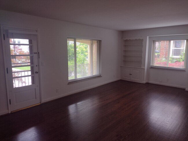 Living Room w/ Door to Balcony - 5702 Doerger Ln Apartments