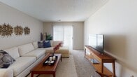 This single-floor residence offers a thoughtfully designed layout that balances functionality and comfort across its main living spaces. The kitchen is a standout feature, showcasing rich dark cabinetry paired with light granite-style countertops, stainless steel appliances including a refrigerator, dishwasher, microwave, and range, plus a built-in wine rack accent and durable hardwood-style flooring. A double basin sink and ample upper and lower cabinet storage make this kitchen as practical as it is visually appealing.

The living room provides a comfortable, open atmosphere with plush carpeting, neutral-toned walls, and a sliding glass door that welcomes natural light. The space is well-suited for both relaxing and entertaining.

Both bedrooms feature soft carpeting, ceiling fans with light fixtures, and generous closet space. Natural light filters through windows dressed with blinds and curtain panels, creating a warm and restful environment.

The two bathrooms are finished with neutral tones and brushed nickel fixtures. One bathroom features a full soaking tub with an overhead shower, while the other offers a walk-in shower with sliding glass doors — providing convenient options for residents.