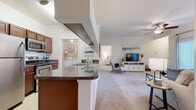 Located at 1500 Royal Gold Dr in Columbus, Ohio, this single-floor residence offers a well-designed, open-concept layout that seamlessly connects the main living areas. The spacious living room features plush carpeting, crown molding, a ceiling fan, and large sliding glass doors that flood the space with natural light and provide direct access to a private outdoor patio with green views.

The kitchen is efficiently arranged in a galley style, featuring warm wood cabinetry, dark granite-style countertops, tile flooring, and a full suite of stainless steel appliances including an electric range, built-in microwave, and dishwasher. A peninsula with a breakfast bar connects the kitchen to the open dining and living areas. A dedicated in-unit laundry room with a full-size washer and dryer is conveniently accessible directly from the kitchen.

The residence includes multiple well-proportioned bedrooms, each with soft carpeting, ceiling fans or ample lighting, and large windows that invite natural light and outdoor views. Walk-in closet access is featured in at least one bedroom. Two full bathrooms are finished with tile flooring, rich wood vanities with granite-style counters, large mirrors, and tub/shower combinations, maintaining a consistent, cohesive aesthetic throughout the home.