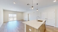 Located at 41 Mt Ebo Rd N in Brewster, NY, this thoughtfully designed 2-bedroom, 3-bathroom residence offers a clean, modern aesthetic with high-quality finishes throughout its well-appointed single floor. Light wood flooring flows seamlessly across every room, creating a warm, cohesive feel.

The open-concept kitchen and living area serves as the heart of the home. The kitchen features a large center island with a quartz countertop, an undermount sink, and warm wood cabinetry complemented by a classic white subway tile backsplash. Stainless steel appliances, globe pendant lighting, and a spacious pantry closet complete the space. The adjoining living area is bright and airy, with sliding glass doors opening to an outdoor balcony and views of the surrounding landscape.

The primary bedroom is generously sized, featuring large windows that invite abundant natural light and scenic outdoor views. The second bedroom is equally bright, with a sizable window overlooking the natural surroundings. Three well-appointed bathrooms include a tiled walk-in shower, a soaking tub with large-format stone-look tile surround, and a vanity with wood cabinetry and a quartz countertop. Multiple hallways provide practical circulation throughout the layout, adding to the overall functionality of this modern Brewster residence.