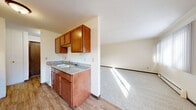 This 610 square foot single-story residence in Saint Paul, Minnesota offers a practical layout with two bedrooms and one bathroom. The property's standout feature is its expansive primary bedroom, measuring an impressive 370 square feet - over half the total floor space. 

The interior is characterized by a neutral color palette, with white walls and ceilings creating a bright, airy atmosphere. Wall-to-wall carpeting in a light gray hue covers the floors throughout, providing comfort and consistency. Large windows in the bedrooms allow for abundant natural light, enhancing the sense of spaciousness.

The home includes two hallways for easy navigation between rooms. Built-in storage solutions are evident, with one bedroom featuring floor-to-ceiling closet doors, maximizing space efficiency. Baseboard heating units are visible, ensuring comfort during Minnesota's cold winters.

While compact, the layout appears well-designed for functionality. The rooms are of a reasonable size, with the living areas and bedrooms offering flexibility for various furniture arrangements. The overall aesthetic is clean and low-maintenance, ideal for those seeking a simple, no-fuss living space in an urban setting.