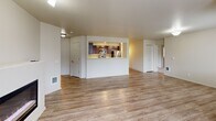 Located in King City, Oregon, this well-appointed two-bedroom, two-bathroom residence offers a thoughtfully designed single-floor layout. The open-concept living, dining, and kitchen area serves as the heart of the home, featuring durable wood-look flooring and an abundance of natural light from multiple large windows. The kitchen is a standout, showcasing rich dark-wood cabinetry, stainless steel appliances including a refrigerator, range, and microwave, white countertops, a double sink, and track lighting overhead — all framed by a convenient pass-through opening to the living area. The spacious primary bedroom is carpeted, bathed in natural light, and includes a walk-in closet with wire shelving. The second bedroom is equally well-lit with comfortable carpeting and its own closet access. Both bathrooms feature wood-look flooring, with one offering a tub/shower combination, dark-wood vanity, and a bright window. A dedicated in-unit laundry room houses a full-size washer and dryer. Four closets throughout provide generous storage. A balcony offers an outdoor retreat, and a pantry adds additional convenience. The interior palette of neutral tones and clean finishes creates a bright, move-in-ready ambiance throughout.