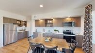 Located at 14378 Walnut Grove Way in Oregon City, Oregon, this well-appointed single-floor residence offers three bedrooms and two bathrooms across a thoughtfully designed layout. Light hardwood flooring flows consistently throughout, creating a cohesive and warm aesthetic.

The open-concept kitchen and dining area serves as the heart of the home. The kitchen features warm wood-toned cabinetry, white quartz countertops, a classic subway tile backsplash, open display shelving, and a full suite of stainless steel appliances. The adjacent dining space provides a natural gathering area that connects seamlessly to the living room.

The hallway entrance is welcoming, accented by recessed lighting and wall space suited for artwork. Each bedroom benefits from natural light through well-positioned windows with neighborhood views. The spacious primary bedroom offers ample room to furnish comfortably. The additional bedrooms are versatile, with one serving well as a home office or flex space.

The bathrooms are finished with modern wood-grain vanities, white quartz countertops, large mirrors, and clean white walls that maximize brightness. Throughout the home, a neutral color palette, recessed lighting, and consistent flooring unify each room into a cohesive, contemporary living environment.