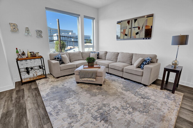 Huge windows in living room and L-shaped couch - 279 W 8th St