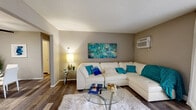 Located at 1800 Park West Blvd in Griffith, Indiana, this one-bedroom, one-bathroom residence offers a thoughtfully designed single-floor layout that maximizes every square foot. The living room features wood-style flooring, neutral gray walls, and large vertical blinds that invite natural light, creating a bright and welcoming atmosphere. A dedicated dining area flows seamlessly from the living space, complete with a ceiling fan and decorative wall mirrors that amplify the sense of openness. The galley-style kitchen is outfitted with dark cabinetry, gray countertops, a stainless steel sink, and wood-style flooring, providing ample storage and a clean, contemporary aesthetic. The bedroom is carpeted for comfort and includes a window with views of the surrounding area, offering a peaceful retreat. Two closets provide generous storage throughout the unit. The bathroom features a full tub-shower combination, wood-style tile flooring, and a vanity with dark cabinetry. Throughout the home, a cohesive neutral color palette accented with modern fixtures and finishes delivers a polished, move-in-ready environment well-suited for comfortable everyday living.