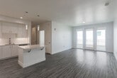 Located at 1785 Almaden Road in San Jose, CA, this thoughtfully designed 2-bedroom, 2-bathroom residence offers a clean, modern aesthetic throughout its well-proportioned single-floor layout. The open-concept living and dining area is anchored by light wood-style flooring, crisp white walls, and a wall-mounted split AC unit. Glass balcony doors invite natural light and provide direct access to a private outdoor balcony. The contemporary kitchen is a standout feature, boasting white shaker cabinetry, quartz countertops, a subway tile backsplash, stainless steel appliances including a refrigerator, range, and microwave, and a central island with pendant lighting — ideal for both cooking and casual dining. A convenient in-unit laundry closet is tucked neatly off the hallway. The spacious primary bedroom features plush carpeting, a mirrored sliding closet, a dedicated split AC unit, and an ensuite bathroom with a dual-sink vanity, quartz countertops, and a walk-in shower. The second bedroom is generously sized with carpet flooring, a window, and a built-in closet. The second bathroom offers a full tub/shower combo with bronze fixtures and a white vanity. Three closets throughout the unit provide ample storage.