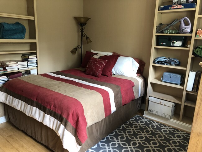 Guest bedroom 2 fits a full size bed and has custom shelves painted to match the room. This room works well as a study as well as a bedroom. - 10997 Crescent Dr