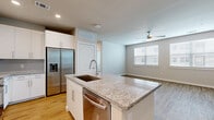 Located in Houston, TX, this well-designed 1-bedroom, 1-bathroom unit offers a thoughtfully laid-out single-floor plan that maximizes every square foot of its comfortable living space. The open-concept kitchen and living area serves as the heart of the home, anchored by a central island topped with granite countertops and an undermount sink. White shaker-style cabinetry lines the walls, complemented by a subway tile backsplash and a full suite of stainless steel appliances, including a French door refrigerator with ice and water dispenser, a wall oven, microwave, and dishwasher. Warm wood-look flooring flows seamlessly throughout the entire unit, enhancing the cohesive, modern aesthetic. The living area benefits from natural light through a window fitted with blinds and is finished with a ceiling fan overhead. The bedroom is a well-proportioned retreat featuring dual windows that invite generous natural light, a ceiling fan, and access to a dedicated walk-in closet outfitted with wire shelving. The bathroom offers a granite-topped vanity with ample cabinetry, a tiled tub-shower combination, and continued wood-look flooring. A dedicated laundry room houses a full-size top-load washer and dryer, adding everyday convenience to this polished and practical Houston residence.