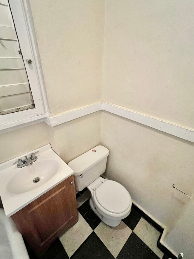 Step into this cozy and functional bathroom, perfect for your morning routine. - Cross Apartments