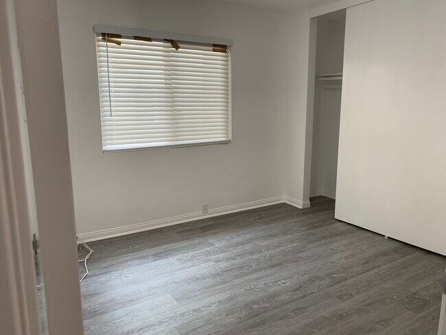Bedroom 1. New flooring, closet rod and shelving. New windows and shutters. Fresh paint. - 6390 Rancho Mission Rd