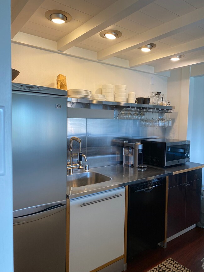 Stainless steel counters and shelving. Dishwasher and microwave. - 121 Madison Ave N