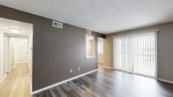 This compact yet well-designed apartment offers 600 square feet of living space on a single floor. The layout includes one bedroom, one bathroom, a living room, dining area, and kitchen, efficiently arranged to maximize functionality.

The interior showcases modern finishes throughout, with a consistent neutral color palette. Wood-look flooring extends across the entire space, providing a cohesive and contemporary feel. The walls are painted in soft, light tones, creating an airy ambiance and enhancing the sense of spaciousness.

The kitchen stands out with its recent updates, featuring crisp white cabinetry, contrasting gray subway tile backsplash, and stainless steel appliances. The countertops appear to be a light-colored quartz or similar material, complementing the overall design.

The bedroom, measuring 170 square feet, offers ample space and includes a large closet with white sliding doors. Windows in the bedroom and living area are fitted with white blinds, allowing for privacy and light control.

The bathroom, while not shown in detail, likely continues the modern aesthetic found throughout the apartment. The unit also includes in-unit laundry facilities, as evidenced by the washer and dryer visible in one of the images.

Overall, this apartment combines efficient design with contemporary styling, creating a comfortable and visually appealing living space ideal for individuals or couples seeking a modern urban lifestyle.