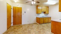 Located at 2615 Marina Blvd in San Leandro, California, this one-bedroom, one-bathroom unit offers a practical and well-organized single-floor layout. The combined kitchen and dining area is finished with durable tile flooring and features warm honey-toned wood cabinetry, ample counter space, a built-in sink, a white electric range, and a full-size refrigerator. A ceiling fan overhead provides year-round comfort. The kitchen opens directly into the carpeted living room, which is brightened by a sliding glass door that leads to a private outdoor patio area, allowing for natural light and easy outdoor access. The bedroom is a generously sized, carpeted room with a large sliding-door closet, a natural light-filled window with outdoor views, and direct access to the hallway. The unit also includes two additional closets for plentiful storage throughout. The bathroom is equipped with a tub and shower combination enclosed by sliding glass doors, a toilet, and a vanity with wood cabinetry. Neutral wall tones and consistent tile flooring in the wet areas create a cohesive, clean aesthetic throughout the unit.