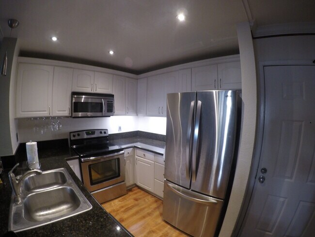 Kitchen with Undercabinet Lighting and Stainless Steel French Door Refrigerator with Ice Maker - 3520 Lebon Dr
