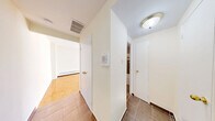 Located at 25 St Mary St in the vibrant Church-Wellesley neighbourhood of Toronto, this one-bedroom, one-bathroom unit offers a compact and efficient layout across a single floor. The living room is the standout space, featuring warm parquet flooring in a classic herringbone pattern and a large picture window that frames striking views of the surrounding downtown skyline, flooding the room with natural light. A baseboard heating system runs along the window wall, ensuring year-round comfort. The bedroom, finished with the same parquet flooring and bright white walls, offers a clean and neutral canvas. The kitchen is efficiently designed with white shaker-style cabinetry, dark granite countertops, a subway tile backsplash, and tile flooring. White appliances including a refrigerator and electric range are included. The bathroom features a full soaker tub with a tiled surround in rich earthy brown tones accented by a crisp white stripe, adding a touch of texture and character. An entryway with exposed brick detailing provides an interesting architectural contrast and connects the spaces cohesively. This unit is ideally situated for those seeking urban convenience in one of Toronto's most walkable and connected neighbourhoods.