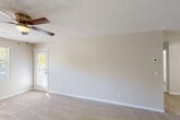Located at 1159 Harrison Pike in Cleveland, Tennessee, this single-floor, 2-bedroom, 3-bathroom home offers a practical and comfortable layout designed for efficient everyday living. The interior features a neutral color palette with warm beige walls, plush wall-to-wall carpeting in the living and bedroom areas, and wood-look hard flooring in the bathrooms and hallway. Textured ceilings and ceiling fans are present throughout the main living spaces, contributing to a relaxed and functional ambiance. The living room is generously proportioned, with natural light filtering through windows and direct access to a private patio. The kitchen connects to a dedicated dining area, completing the main living zone. Each of the two bedrooms is well-sized, with the primary bedroom offering ample room and its own closet among four total closets in the home. The three bathrooms are appointed with white cabinetry, granite-patterned countertops, large mirrors, and brushed nickel fixtures. One bathroom features a combination tub and shower with a handheld showerhead. A dedicated laundry area and a connecting hallway round out the floor plan, providing convenient access to all rooms. The overall layout is thoughtfully organized, making efficient use of the available space throughout.