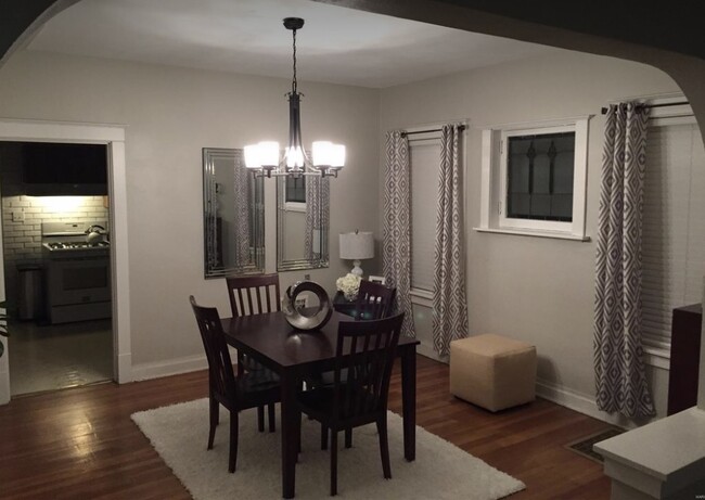 Formal dining room with large stained glass window. - 4398 Holly Hills Blvd