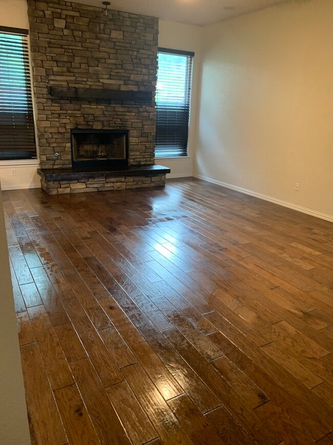 Wood floor in living room and hallways. real fireplace. - 4517 Newport Dr