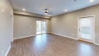 This contemporary 750 square foot apartment offers a harmonious blend of style and functionality. The open-concept design seamlessly integrates the kitchen and living areas, creating a spacious feel. The kitchen boasts white cabinetry, granite countertops, and a full suite of stainless steel appliances, including a refrigerator, stove, microwave, and dishwasher.

The living area features wood-look flooring and recessed lighting, with large sliding glass doors that flood the space with natural light and provide access to a generous private terrace. This outdoor space, finished with herringbone-patterned tiles, offers panoramic views of the surrounding area.

The bedroom, measuring 140 square feet, is carpeted for comfort and includes a window for natural light. The bathroom showcases modern fixtures, including a single vanity with storage and a combination tub/shower.

Convenience is key with an in-unit laundry area featuring a stacked washer and dryer. The apartment's neutral color palette and clean lines create a canvas for personal style. Located at 1601 E Main St in New Albany, IN, this third-floor unit (308) combines urban living with contemporary comfort.