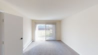 Located at 6615 Fountains Blvd in West Chester, Ohio, this single-floor unit offers a clean, functional layout ideal for comfortable everyday living. The living area is generously sized, featuring plush wall-to-wall carpeting and a large sliding glass door fitted with vertical blinds that floods the room with natural light while providing access to outdoor views. Baseboard heating runs throughout the space, ensuring warmth and efficiency. The bedroom is a well-proportioned, carpeted room equipped with a ceiling fan, a closet, and a window that allows natural light to brighten the space. The kitchen is practical and efficiently designed, featuring warm-toned wood cabinetry, light laminate countertops, a stainless steel sink, and white appliances including a stove and dishwasher. The bathroom is straightforward and clean, highlighted by a full-size soaking tub with an overhead shower, chrome fixtures, and bright white surround walls. Throughout the unit, neutral tones on the walls and ceilings create a bright, airy atmosphere. The overall layout, as seen in the dollhouse view, flows cohesively from the entry through the main living space, kitchen, bedroom, and bathroom, making excellent use of the available footprint.
