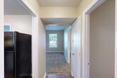 Located at 25 S Germantown Rd in Chattanooga, Tennessee, this one-bedroom, one-bathroom unit offers a practical and well-organized single-floor layout. The space is thoughtfully arranged to maximize functionality, with hallways connecting each area seamlessly.

The living room provides a comfortable gathering space, while the kitchen features white cabinetry, dark countertops, a stainless steel sink, and a black electric range with overhead ventilation — all set atop warm hardwood-style flooring. A window with blinds allows natural light to brighten the kitchen.

The bedroom is a well-proportioned retreat with plush carpeting, neutral beige walls, and two windows that invite abundant natural light and views of the surrounding greenery. Two closets offer generous storage for the space.

The bathroom includes a single vanity with a large mirror, overhead lighting, and a window that adds natural brightness. The layout is clean and efficient.

Throughout the unit, neutral tones, white trim, and carpet in the bedroom and living areas create a cohesive and move-in ready atmosphere. Two hallways ensure smooth flow between rooms, adding to the overall practicality of this well-maintained Chattanooga residence.