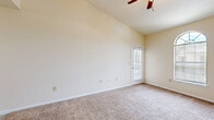 Located at 8217 Avenue U in Lubbock, Texas, this one-bedroom, one-bathroom unit offers a practical and efficiently organized single-floor layout. The kitchen is a standout functional space, featuring white cabinetry with warm wood-tone trim, light vinyl plank flooring, white appliances including a refrigerator, electric range, microwave, and dishwasher, along with ample counter space. Cabinetry storage extends into the adjacent hallway, maximizing utility throughout. The hallway connects the main living areas seamlessly, with a ceiling-mounted light fixture providing clear visibility. The bedroom is a comfortable, well-proportioned room finished with plush wall-to-wall carpeting and neutral cream-toned walls. A window fitted with horizontal blinds allows for natural light and privacy control. The bathroom is clean and practical, featuring wood-toned cabinetry above the vanity, a single-basin sink with white countertops, a full tub and shower combination with white tile surround, and durable vinyl plank flooring that ties in with the kitchen aesthetic. The overall design throughout the unit is straightforward and neutral, offering a clean, move-in-ready environment suited for comfortable everyday living.