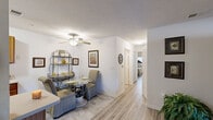 Located at 101 Chandler Rd in Greer, South Carolina, this single-floor, 2-bedroom, 2-bathroom home offers a practical and comfortable layout designed for everyday living. Light wood-style flooring flows throughout the main areas, lending a clean, cohesive aesthetic to the space.

The combined kitchen and living area serves as the heart of the home. The kitchen features warm oak cabinetry with ample upper and lower storage, light countertops, a double basin sink, and a dishwasher. The adjacent living room is generously proportioned, with natural light filtering through windows and an open passageway connecting to a secondary sitting area, creating a smooth and inviting flow.

Both bedrooms are comfortably sized, with the primary bedroom offering a dedicated window with natural light, a closet, and enough room for full bedroom furnishings. Each bedroom benefits from neutral wall tones and the same light flooring found throughout the home.

The two full bathrooms are functionally designed, each featuring a vanity with wood cabinetry, a mirror, and a tub-shower combination with tile flooring. A dedicated laundry room with wire shelving, washer/dryer hookups, and utility connections adds everyday convenience. A hallway connects the private areas of the home seamlessly. Textured ceilings and ceiling fans in key areas complete the practical, well-rounded character of this Greer residence.