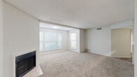 This well-appointed 2-bedroom, 2-bathroom residence in Southaven, Mississippi offers a thoughtfully designed single-floor layout that balances comfort and functionality. The expansive living room serves as the heart of the home, featuring soft wall-to-wall carpeting, a textured ceiling, a classic fireplace, and multiple windows dressed with blinds that flood the space with natural light. The open-concept flow connects the living area seamlessly to the dining space and a galley-style kitchen equipped with stainless steel appliances — including a range, microwave, refrigerator, and dishwasher — complemented by white cabinetry, grey countertops, and light hardwood-style flooring. The primary bedroom offers a generous footprint with plush carpeting, a ceiling fan, and a large double-door closet for ample storage. The second bedroom is equally comfortable, also featuring carpeted floors and closet space. Both bathrooms are finished with light wood-style flooring, white vanities with grey countertops, and clean, neutral tones. A dedicated laundry area and additional hallway closets add to the home's practical appeal. Throughout, the neutral color palette and consistent finishes create a bright, cohesive ambiance.