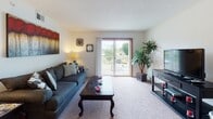 This two-bedroom, one-bathroom residence in Tupelo, Mississippi offers a well-organized single-floor layout designed for comfortable everyday living. The living room serves as the heart of the home, featuring carpet flooring, a textured ceiling, and a sliding glass door that opens to a private balcony with open outdoor views, allowing natural light to fill the space. Adjacent to the living area is a dedicated dining space with carpet flooring and direct access to the kitchen through a pass-through counter, making it ideal for casual meals and entertaining. The galley-style kitchen is efficiently designed with white cabinetry, ample counter space, a double-basin sink, and a full suite of appliances including a refrigerator and electric range, all set on easy-to-maintain tile flooring. The primary bedroom is generously sized with carpet flooring, a walk-in closet, and a conveniently connected bathroom featuring a single-sink vanity and a shower/tub combination with tile flooring. The second bedroom also offers carpet flooring, a window with natural light, and a closet with built-in shelving. The shared full bathroom provides a clean, functional layout with a wide vanity. Throughout the residence, warm-toned wood accents on doors and trim add a cohesive, welcoming character to the space.