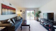 This two-bedroom, one-bathroom residence in Tupelo, Mississippi offers a well-organized single-floor layout designed for comfortable everyday living. The living room serves as the heart of the home, featuring carpet flooring, a textured ceiling, and a sliding glass door that opens to a private balcony with open outdoor views, allowing natural light to fill the space. Adjacent to the living area is a dedicated dining space with carpet flooring and direct access to the kitchen through a pass-through counter, making it ideal for casual meals and entertaining. The galley-style kitchen is efficiently designed with white cabinetry, ample counter space, a double-basin sink, and a full suite of appliances including a refrigerator and electric range, all set on easy-to-maintain tile flooring. The primary bedroom is generously sized with carpet flooring, a walk-in closet, and a conveniently connected bathroom featuring a single-sink vanity and a shower/tub combination with tile flooring. The second bedroom also offers carpet flooring, a window with natural light, and a closet with built-in shelving. The shared full bathroom provides a clean, functional layout with a wide vanity. Throughout the residence, warm-toned wood accents on doors and trim add a cohesive, welcoming character to the space.