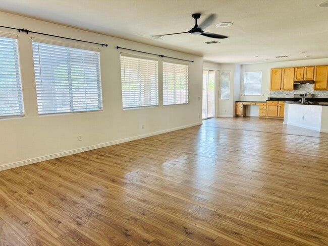 Spacious family room with abundant natural light and wood-look flooring. - 1177 W Laredo Ave