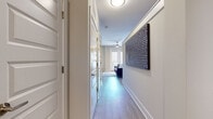 Located at 606 N Carolina Music Factory Blvd in Charlotte, NC, this single-floor residence offers a thoughtfully designed layout with contemporary finishes throughout. Light wood-look flooring flows seamlessly across the main living areas, creating a cohesive and airy feel.

The living room is an inviting space featuring built-in shelving, a dedicated entertainment area, and a convenient wet bar nook — ideal for both relaxing and entertaining. The open sightlines connect the living area to the kitchen, which is outfitted with stainless steel appliances including a range, microwave, and French door refrigerator, complemented by sleek two-tone cabinetry and a light tile backsplash.

A well-proportioned hallway lined with closet storage leads to the bedroom, which features plush carpeting, a bold accent wall, and a walk-in closet offering generous storage. The bathroom is finished with tile flooring, a full tub-shower combination with stylish patterned curtains, and a dark wood vanity with a clean white countertop.

The space balances modern design with functional living, making it a comfortable and well-equipped urban residence in one of Charlotte's most vibrant entertainment districts.