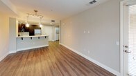 Located at 7800 Westside in San Diego, Unit #202 is a thoughtfully designed single-floor residence that combines modern aesthetics with functional living spaces. The open-concept layout connects the living and dining areas seamlessly, featuring warm wood-look flooring, neutral-toned walls, and a contemporary track lighting fixture that adds both style and illumination. A large window fills the dining area with natural light, enhancing the airy atmosphere.

The kitchen is a standout feature, outfitted with rich dark espresso cabinetry, crisp white countertops, and a full suite of stainless steel appliances, including a gas range, built-in microwave, and refrigerator. Recessed lighting and wood-look flooring complete the polished look. A breakfast bar with pendant lighting provides a seamless transition to the living area.

The bedroom is a comfortable retreat with plush carpet flooring and neutral walls. French doors open to an outdoor area, filling the room with natural light and providing a pleasant connection to the exterior. An additional bedroom or flexible room features the same soft carpeting and easy access to the rest of the unit.

The bathroom is clean and functional, featuring a full soaking tub and shower combination with chrome fixtures. In-unit laundry is also conveniently accessible, adding to the practicality of this well-rounded San Diego residence.