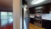 Located on Christine Court in Fremont, CA, this single-story home offers a well-designed layout with a cohesive blend of modern updates and functional living spaces. The kitchen is a standout feature, showcasing dark espresso cabinetry extending to the ceiling for ample storage, stainless steel appliances including a gas range, built-in microwave, and refrigerator, complemented by light countertops and a decorative mosaic tile backsplash. Light hardwood flooring runs throughout the kitchen and living areas, adding warmth and continuity to the space.

The living area is generously proportioned, featuring a ceiling fan and an open sightline into the kitchen, creating a connected and airy feel. A sliding door provides access to an outdoor area, allowing natural light to filter in.

The bedrooms are carpeted for comfort, each featuring windows with blinds that bring in natural light and views of surrounding greenery. One bedroom includes mirrored sliding closet doors, enhancing the sense of space.

The bathrooms are neatly appointed, with one featuring a dark wood vanity with under-sink storage and a mirror, while a second bathroom includes a full tub-shower combination with built-in shelving. Clean, neutral tones throughout contribute to a calm and cohesive overall ambiance.