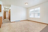 Located at 1118 Mark Ave in Tomah, Wisconsin, this single-story home offers a practical and comfortable layout across four bedrooms and one full bathroom. The open-concept living, dining, and kitchen area forms the heart of the home, providing a seamless flow for everyday living and entertaining. The kitchen is well-appointed with warm oak cabinetry, white countertops, a built-in range, dishwasher, refrigerator, and a peninsula that adds additional prep space and visual separation from the dining area. Light tile flooring runs throughout the kitchen, while neutral carpet covers the living areas and bedrooms, creating a cohesive and move-in-ready feel. Each bedroom is generously proportioned with carpeted floors, individual closets, and natural light from windows. The primary bedroom offers a notably spacious footprint with its own closet. The full bathroom features a tub/shower combo, a single-sink vanity with oak cabinetry, a large mirror, and tile flooring. Six closets throughout the home provide ample storage. An attached garage with an automatic opener rounds out the property, offering convenient enclosed parking and additional utility space. White walls, wood-trimmed doors, and textured ceilings are consistent throughout, giving the home a clean, uniform character.