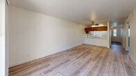 Located at 1701 Ellis Lake Dr in Marysville, CA, this single-floor residence offers three bedrooms, one bathroom, and a practical, well-organized layout. The open living room is bright and spacious, featuring light wood-look flooring, a ceiling fan, and a sliding glass door that opens to a private balcony with outdoor views, allowing natural light to fill the space. The kitchen flows directly off the living area and is equipped with warm oak cabinetry, a white electric range, built-in microwave, dishwasher, and refrigerator, all set over light wood-look flooring that ties the shared spaces together cohesively. A hallway with wood-toned doors connects the main living area to the three bedrooms, each finished with neutral carpet and windows with blinds that provide natural light and a calm, comfortable atmosphere. The primary bedroom offers a generous footprint with ample wall space. The shared bathroom features a wide dual-sink vanity with oak cabinetry, a light countertop, a large wall mirror with lighted fixtures, and wood-look flooring, providing a clean and functional space. Throughout the residence, neutral tones and consistent finishes create a cohesive and move-in-ready environment.