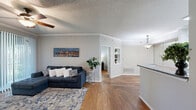 Located at 920 Meadow Creek Dr in Irving, TX, this one-bedroom, one-bathroom unit offers a well-organized single-floor layout designed to maximize functionality. The combined kitchen and living area forms the heart of the space, where warm hardwood-style flooring, crown molding, and a textured ceiling create a cohesive aesthetic throughout. The kitchen features white cabinetry, granite-style countertops, stainless steel appliances, and a curved breakfast bar that opens directly to the living area, promoting a connected, open feel. The living room benefits from a ceiling fan with light fixture and a sliding glass door fitted with vertical blinds, allowing natural light to filter in while providing a view of the outdoor greenery beyond.

The bedroom is a well-proportioned retreat, finished with matching hardwood-style floors, crown molding, a ceiling fan, and a window that brings in additional natural light. A dedicated closet provides convenient storage. The bathroom is cleanly appointed with white cabinetry, a granite-style vanity countertop, a large mirror, and tile-accented shower walls. A separate laundry area accommodates a full-sized washer and dryer side by side, complete with wire shelving above for added storage. The unit offers a practical and comfortable living environment throughout.