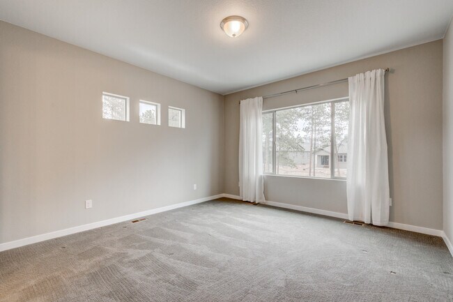 Main level master bedroom with attached bathroom - 16393 Corkbark Terrace