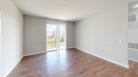 Located at 400 W Claiborne Rd in North East, MD, this single-floor, 2-bedroom, 2-bathroom residence offers a thoughtfully designed layout that balances functionality and modern style. The open-concept living and kitchen area serves as the heart of the home, featuring rich hardwood-style flooring, neutral-toned walls, and sliding glass doors that open to a private balcony with outdoor views, flooding the space with natural light.

The kitchen is a standout feature, equipped with dark espresso cabinetry, granite countertops, a central island with a built-in sink, stainless steel appliances including a range and microwave, and both pendant and track lighting overhead. The galley-style layout maximizes counter and storage space efficiently.

Both bedrooms are carpeted and bathed in natural light through large windows with blinds that overlook the surrounding neighborhood. The spacious primary bedroom offers a comfortable retreat, while the second bedroom is equally well-sized and versatile.

The two bathrooms are finished with wood-style flooring and dark vanity cabinetry with granite countertops. One bathroom features a glass-enclosed walk-in shower, while the other provides a clean, functional layout. Two closets and two hallways complete the floorplan, ensuring ample storage and easy circulation throughout the residence.