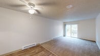 Located in Portland, Oregon, this 2-bedroom, 1-bathroom unit offers a practical and comfortable layout across a single floor. The entry hallway transitions seamlessly into the combined living and dining area, where wood-style flooring gives way to wall-to-wall carpeting. The spacious living room is bright and open, featuring a ceiling fan, baseboard heating, a textured ceiling, and a sliding glass door that leads to a private balcony with outdoor views of the surrounding greenery.

The kitchen is efficiently designed with white cabinetry, a cooktop island peninsula, a dishwasher, refrigerator, and a window that brings in natural light. It flows directly into the dining area, creating a connected, functional space.

Both bedrooms are carpeted and filled with natural light from large windows. Each bedroom is equipped with a sliding-door closet, and the unit as a whole offers an impressive five closets, providing generous storage throughout. The full bathroom includes a vanity with counter space, a tub-shower combination, and wood-style flooring.

Baseboard heating is present throughout the unit, ensuring consistent warmth. The overall aesthetic is clean and neutral, with white walls and light tones creating a bright, move-in-ready environment.