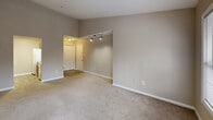 This well-organized 2-bedroom, 1-bathroom single-floor home in Marietta, Georgia offers a functional and comfortable layout. The combined living and dining area is bright and inviting, featuring plush carpet flooring, neutral warm-toned walls, and a large picture window that floods the space with natural light. A secondary door provides additional access, enhancing the open, airy feel of the room. Track lighting near the entrance adds a practical design touch.

The galley-style kitchen is efficiently designed with warm wood cabinetry lining both sides, light countertops, white appliances including a range, refrigerator, and dishwasher, and easy-care vinyl plank flooring. A pass-through counter connects the kitchen to the living area, making the space feel open and connected.

Both bedrooms are carpeted and feature ceiling fans, generous natural light from large windows with blinds, and access to the six closets distributed throughout the home. The primary bedroom offers a comfortable, well-proportioned retreat.

The hallway leads to the full bathroom, which includes a tiled tub-shower combination with chrome fixtures. Additional highlights include a dedicated laundry area and a utility room. The neutral color palette and consistent finishes throughout create a cohesive, move-in ready atmosphere.