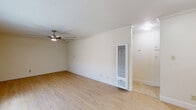 Located in the Eagle Rock neighborhood of Los Angeles, this single-story 2-bedroom, 1-bathroom home offers a well-organized and functional layout. The living room welcomes you with light wood flooring, crown molding, a ceiling fan, and a large window fitted with vertical blinds that invites natural light while providing privacy. A wall-mounted heating unit adds a practical touch to the space.

The kitchen flows directly from the living area and features crisp white shaker cabinetry, dark granite countertops, a stainless steel sink, and durable wood-look flooring — a clean and efficient space for everyday use.

Both bedrooms are carpeted and finished with crown molding and ceiling fans with light fixtures. The primary bedroom is generously sized, offering a full wall of mirrored sliding closet doors that enhance the sense of space and provide ample storage. A window with vertical blinds allows for natural light and ventilation.

The bathroom is well-appointed with tile flooring, a tub and shower combo enclosed by sliding glass doors, beige tile surround, a white vanity with dark granite countertop, and a mirrored medicine cabinet. A frosted window above the tub provides natural light.

Throughout, the home maintains a consistent, neutral palette with clean finishes, making it a practical and comfortable residence in Los Angeles.