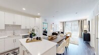 This contemporary 960 square foot apartment offers a harmonious blend of style and functionality. The open-concept living area seamlessly integrates the kitchen and living room, creating a spacious feel. The kitchen boasts sleek white cabinetry, stainless steel appliances, and a convenient island with seating, perfect for casual dining or entertaining.

The living room is bathed in natural light from large windows and features modern furnishings, including a comfortable sofa and stylish accent chair. Abstract artwork and a unique circular mirror add visual interest to the space.

Both bedrooms are well-appointed, with the primary bedroom measuring 170 square feet. The rooms showcase a neutral color palette with pops of color in the bedding and decor. Each bedroom has its own ensuite bathroom, finished with modern fixtures and ample storage.

Throughout the apartment, you'll find thoughtful design elements such as geometric patterns in the rugs and curtains, and a mix of textures in the furnishings. The space also includes two closets, one of which is a walk-in with a well-organized shelving system.

Hardwood-style flooring runs throughout most of the apartment, while plush carpeting adds comfort in the bedrooms. Recessed lighting and contemporary light fixtures provide a warm ambiance.

This apartment at 1125 Virginia Dr, Fort Washington, PA, offers a perfect blend of modern aesthetics and practical living, ideal for those seeking a stylish urban lifestyle.