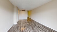 Located at 4000 58th St N in Kenneth City, Florida, this single-floor, 2-bedroom, 1-bathroom residence offers a practical and well-organized layout. Wood-look plank flooring runs throughout, lending a cohesive, modern feel to every room, while textured ceilings add a classic Florida character.

The combined living and dining area serves as the heart of the home, featuring a ceiling fan, neutral warm-toned walls, and a sliding glass door that opens to a balcony with outdoor views — filling the space with natural light. The kitchen is positioned adjacent to the living area and is equipped with white shaker-style cabinetry, light countertops, and a full-size black refrigerator.

Both bedrooms are comfortably sized, with the spacious primary bedroom offering a ceiling fan, a sliding closet, and a window with vertical blinds. The second bedroom also features a window and ceiling light fixture. The residence includes three closets in total, providing ample storage throughout.

The bathroom features a tiled tub/shower combination with a window for ventilation. A dedicated laundry area and a hallway connecting the rooms complete this efficiently designed home.