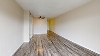Located at 4000 58th St N in Kenneth City, Florida, this single-floor, 2-bedroom, 1-bathroom residence offers a practical and well-organized layout. Wood-look plank flooring runs throughout, lending a cohesive, modern feel to every room, while textured ceilings add a classic Florida character.

The combined living and dining area serves as the heart of the home, featuring a ceiling fan, neutral warm-toned walls, and a sliding glass door that opens to a balcony with outdoor views — filling the space with natural light. The kitchen is positioned adjacent to the living area and is equipped with white shaker-style cabinetry, light countertops, and a full-size black refrigerator.

Both bedrooms are comfortably sized, with the spacious primary bedroom offering a ceiling fan, a sliding closet, and a window with vertical blinds. The second bedroom also features a window and ceiling light fixture. The residence includes three closets in total, providing ample storage throughout.

The bathroom features a tiled tub/shower combination with a window for ventilation. A dedicated laundry area and a hallway connecting the rooms complete this efficiently designed home.