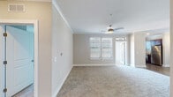 Located in Colorado Springs, CO, this single-floor residence presents a thoughtfully designed layout with a neutral color palette and quality finishes throughout. The open living area features plush carpeting, crown molding, and a ceiling fan with light fixture, creating a comfortable and airy atmosphere. Natural light filters in through blinds-equipped windows, and a door provides direct access to an outdoor space.

The kitchen is well-equipped with rich dark wood cabinetry, granite-style countertops, a subway tile backsplash, stainless steel appliances including a range and dishwasher, an undermount sink, and wood-look flooring — offering both functionality and visual appeal.

The primary bedroom is generously sized with carpeting, crown molding, a ceiling fan, and a walk-in closet. Its en-suite bathroom features a dual-sink vanity with dark wood cabinetry, granite countertops, wood-look flooring, framed mirrors, and a glass-enclosed shower. Additional bedrooms each include carpeting and closet storage. A secondary bathroom offers a tub-shower combination with a curved rod, dark cabinetry, and wood-look flooring, completing this well-appointed residence.